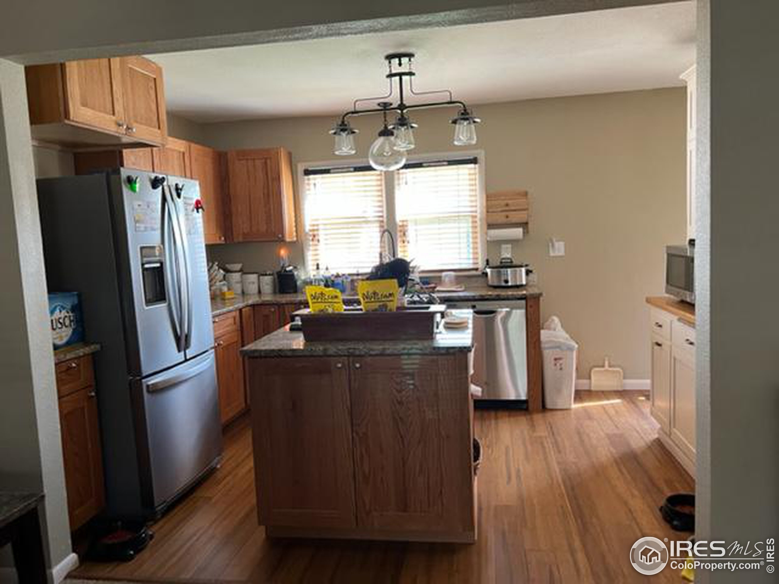 1124 West 7th Street Wray, CO 80758 - Photo 7 of 11 a kitchen with stainless steel appliances granite countertop a refrigerator a stove a sink and a window
