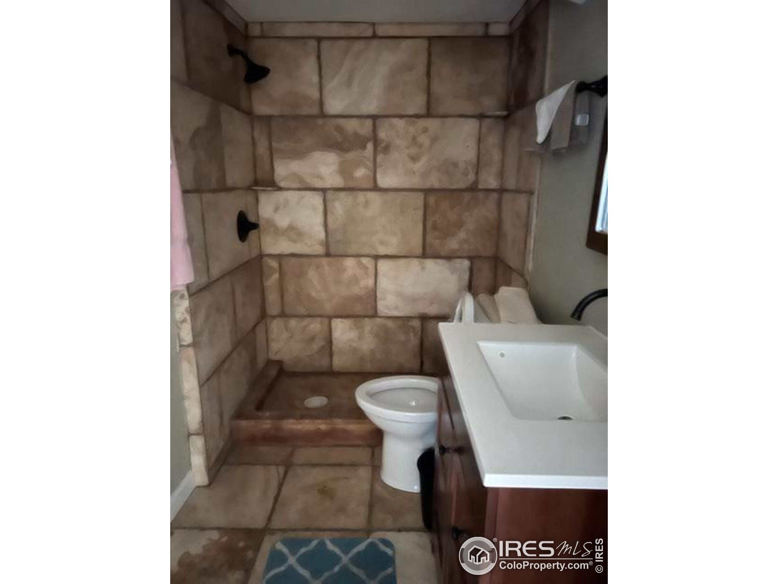 1124 West 7th Street Wray, CO 80758 - Photo 10 of 11 a bathroom with a toilet and a sink