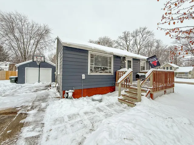 a view of a house with wooden roof and sitting area