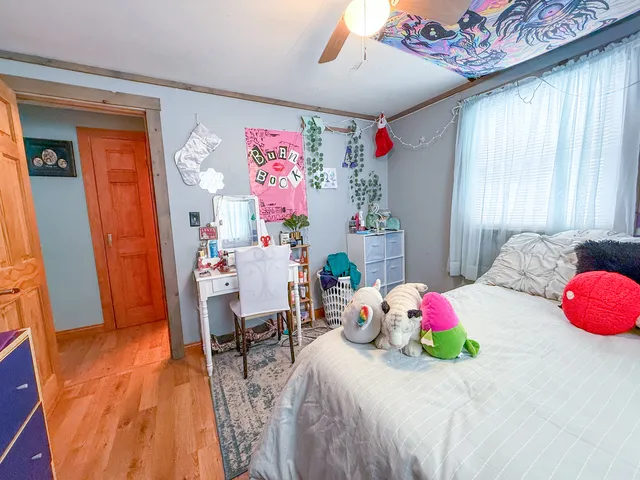 a bedroom with a bed and a chandelier