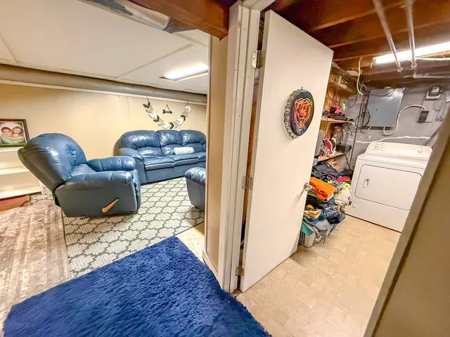 a living room with chairs and kitchen view