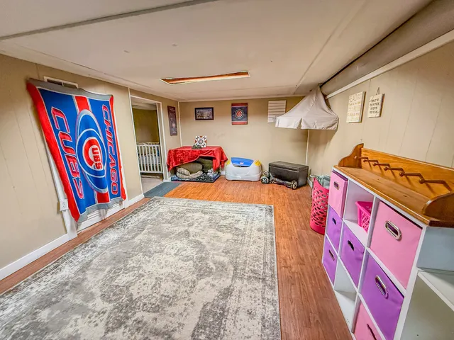 a utility room with stainless steel appliances wooden floor and large window