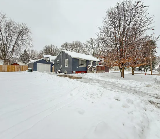 a view of a white house with a snow on the road