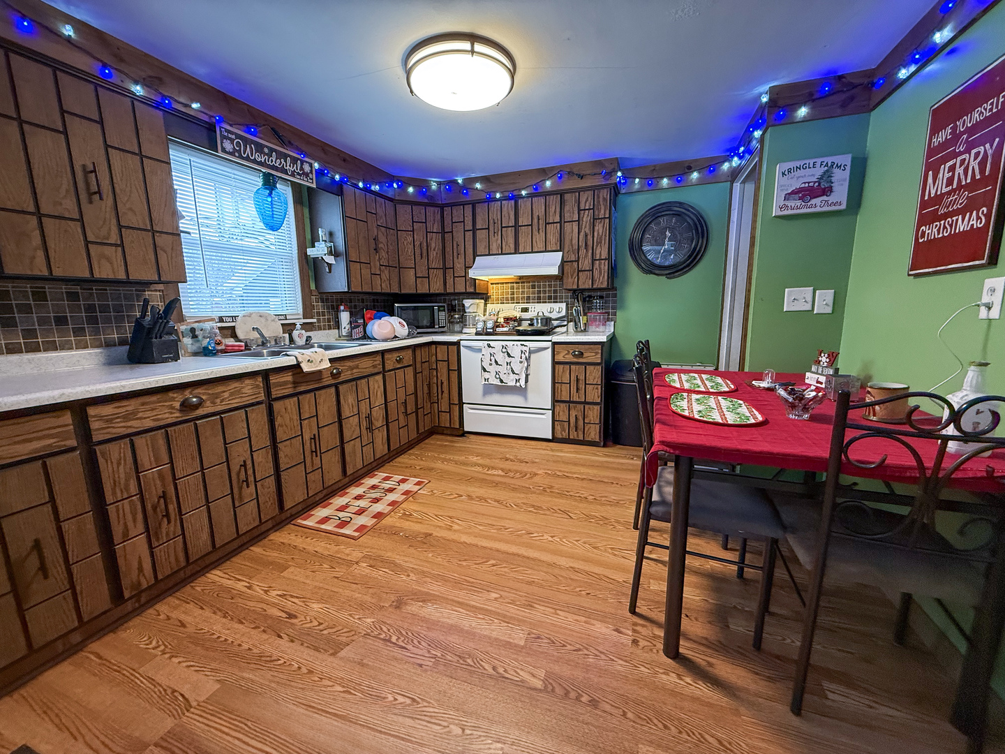 615 West 9th Street Sterling, IL 61081 - Photo 9 of 30 a kitchen with a wooden cabinets and chairs