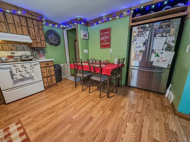 a kitchen with stainless steel appliances granite countertop a refrigerator and stove top oven