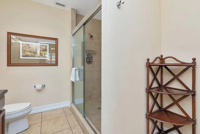 a bathroom with a toilet and a shower