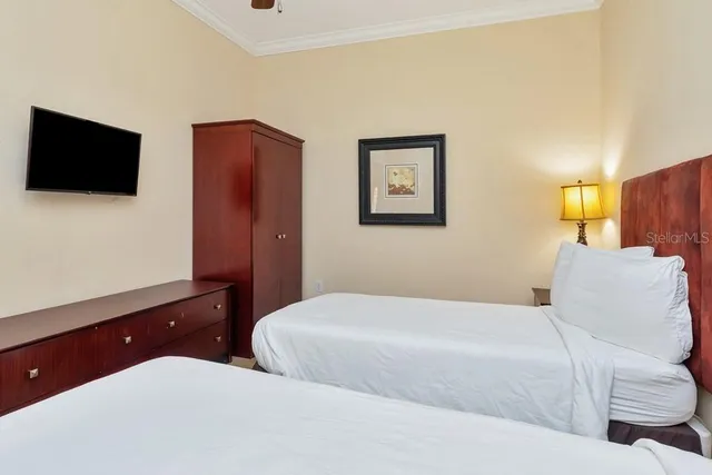 a bedroom with a bed and a flat screen tv