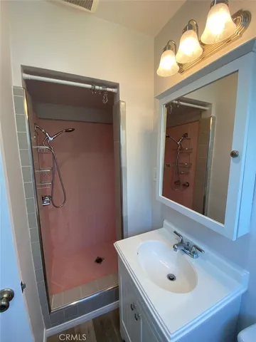 a bathroom with a sink a mirror and vanity