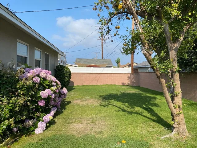 a view of a house with a yard and garden