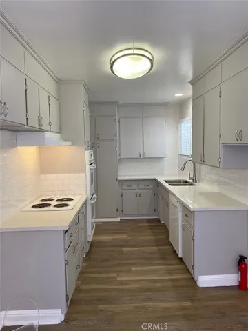 a kitchen with a sink stove and cabinets