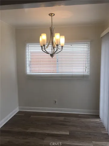 a view of a room with wooden floor and window