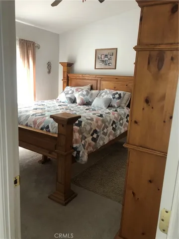 a bed sitting in a bedroom next to a window