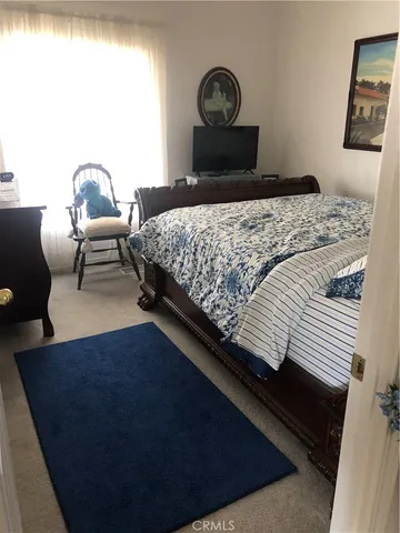 a bedroom with a bed lamp and a window