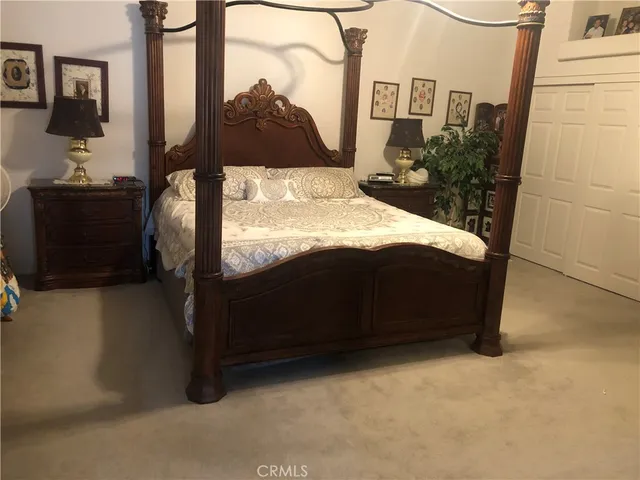a bedroom with a bed and dresser