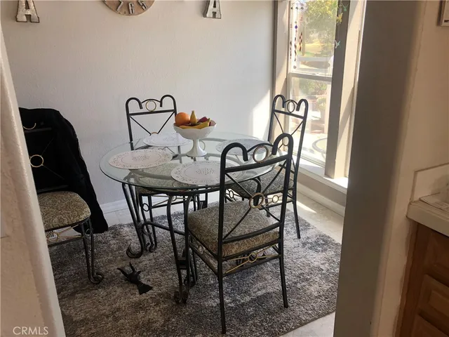 a view of a dining room with furniture and a window