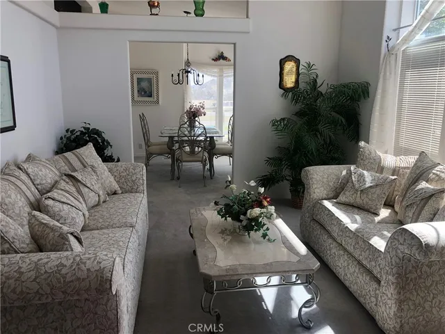 a living room with furniture and flowers
