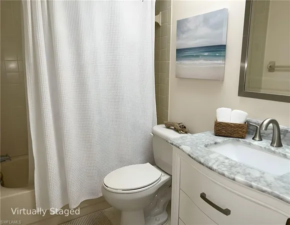 a bathroom with a granite countertop sink and a toilet