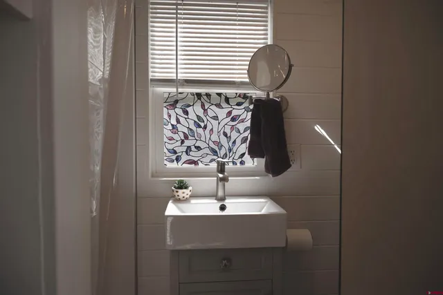 a bathroom with a sink and mirror