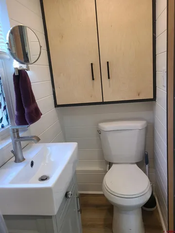 a bathroom with a toilet sink and mirror