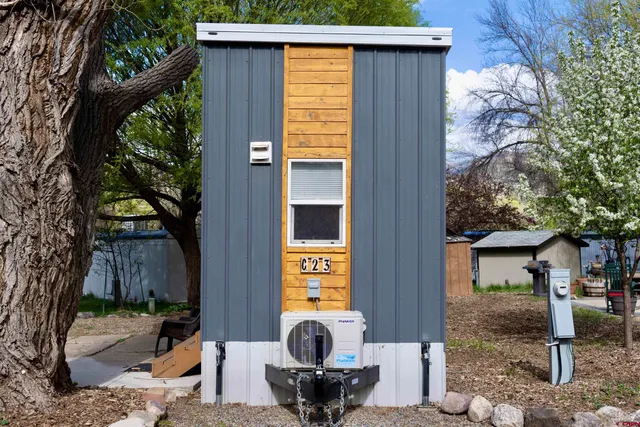 a view of a house with backyard and sitting area