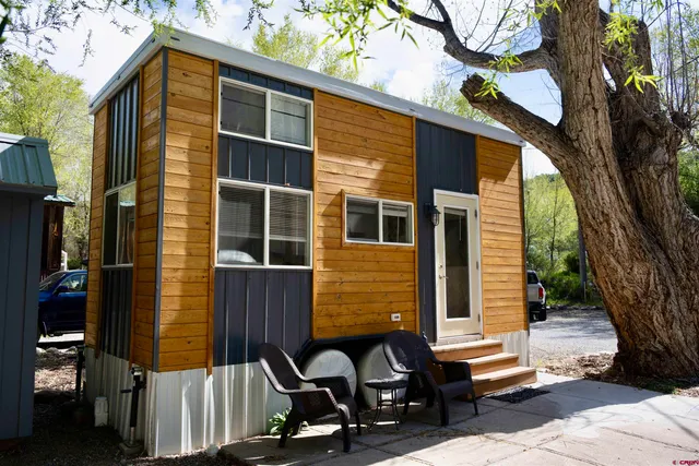 a front view of a house with a bench