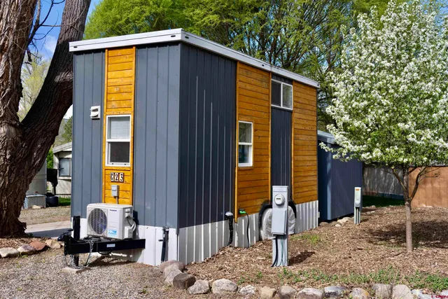 a front view of a house with outdoor seating