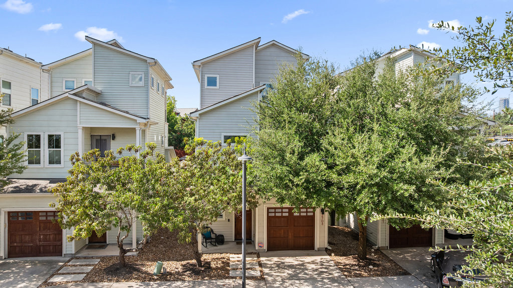 a front view of a house with a tree