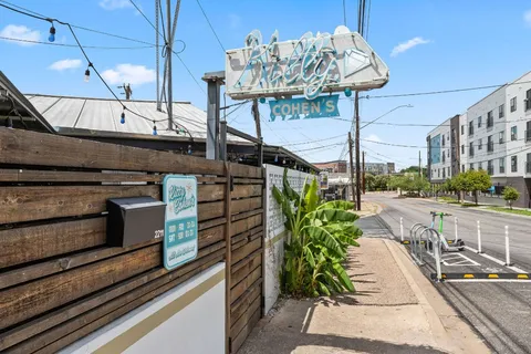 a city view from a balcony with seating space