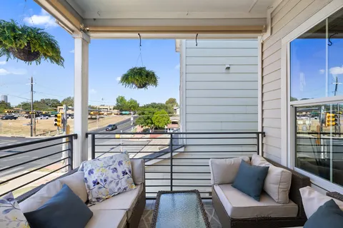 a view of a balcony with furniture and a potted plant