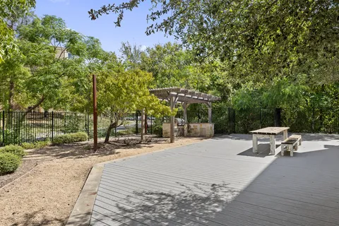 a backyard of a house with table and chairs