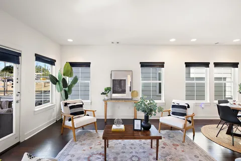 a living room with furniture a window and a flat screen tv