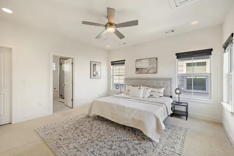 a bedroom with a large bed and a window