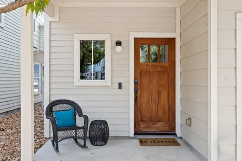 a view of front door with two windows