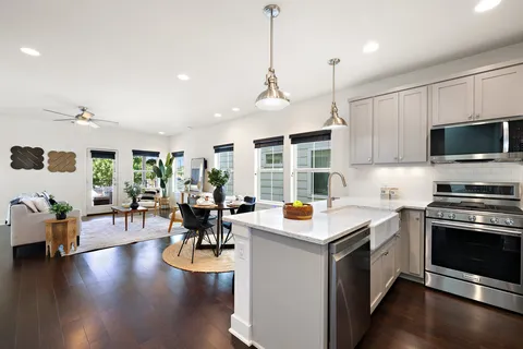 a kitchen with a stove cabinets and wooden floor