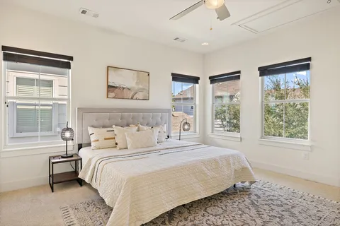 a bedroom with a large bed and a window