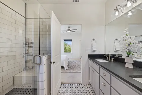 a bathroom with a granite countertop sink a toilet and shower