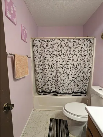 a bathroom with a bathtub and shower curtain