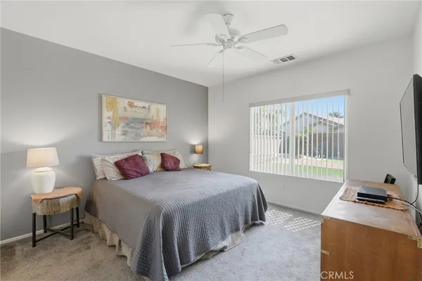 a bedroom with a bed and a table