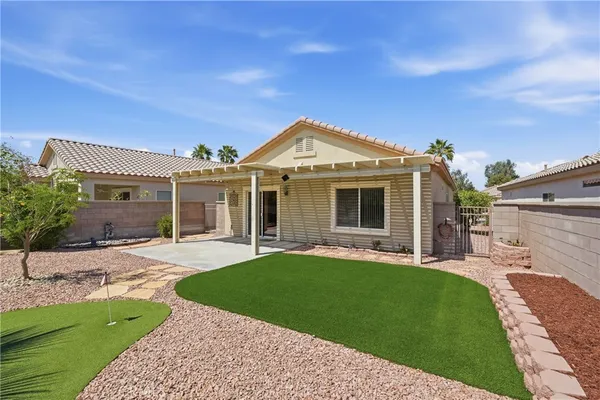 a front view of a house with a garden and yard