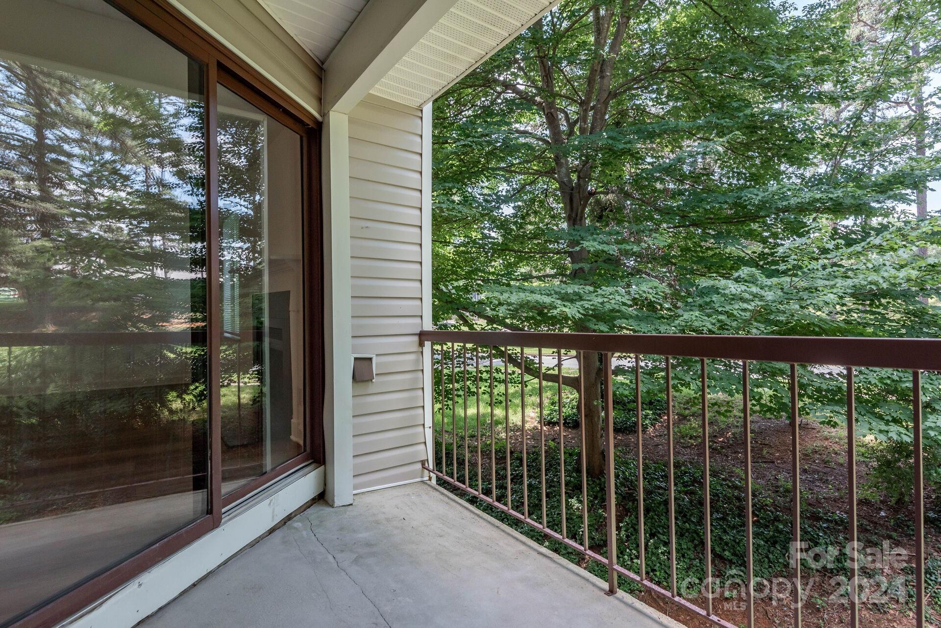 7516 Pebblestone Drive, Unit E Charlotte, NC 28212 - Photo 12 of 21 a view of a balcony with a tree