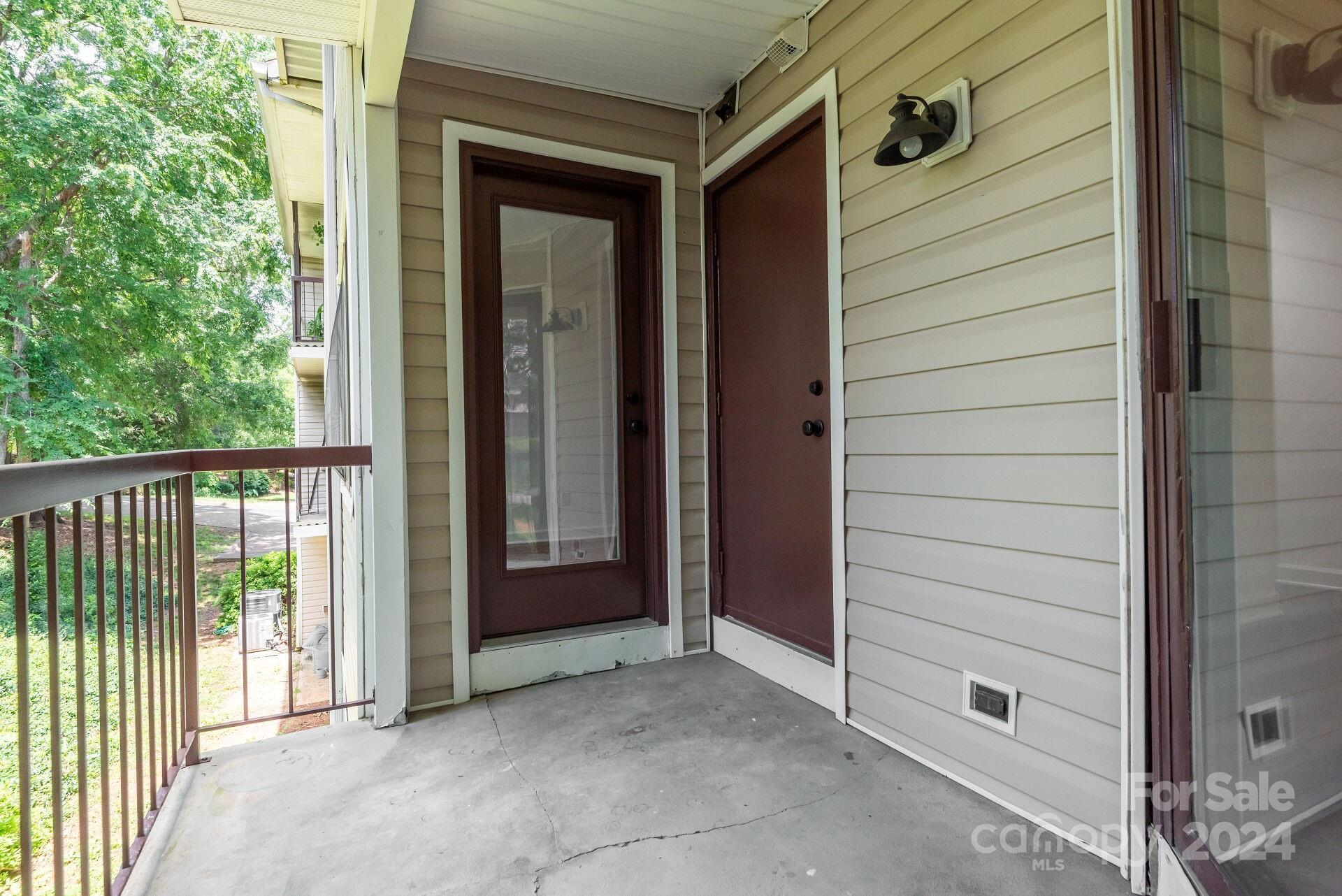 7516 Pebblestone Drive, Unit E Charlotte, NC 28212 - Photo 13 of 21 a view of a porch with a door and wooden fence