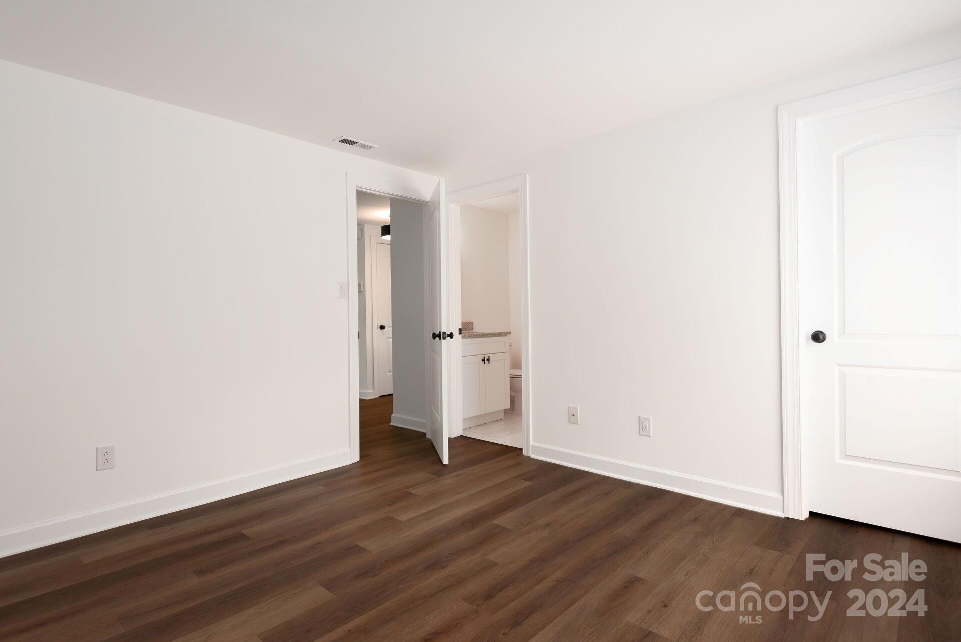 7516 Pebblestone Drive, Unit E Charlotte, NC 28212 - Photo 15 of 21 an empty room with wooden floor