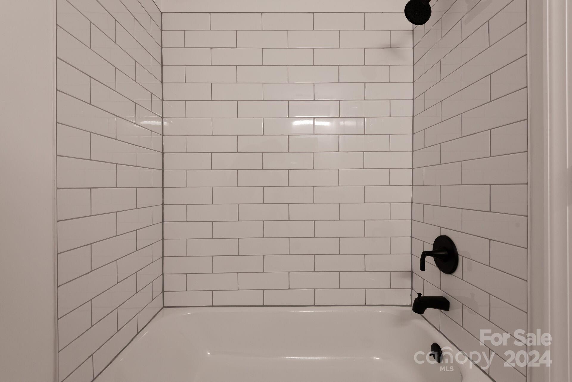 7516 Pebblestone Drive, Unit E Charlotte, NC 28212 - Photo 17 of 21 a bathroom with a bathtub