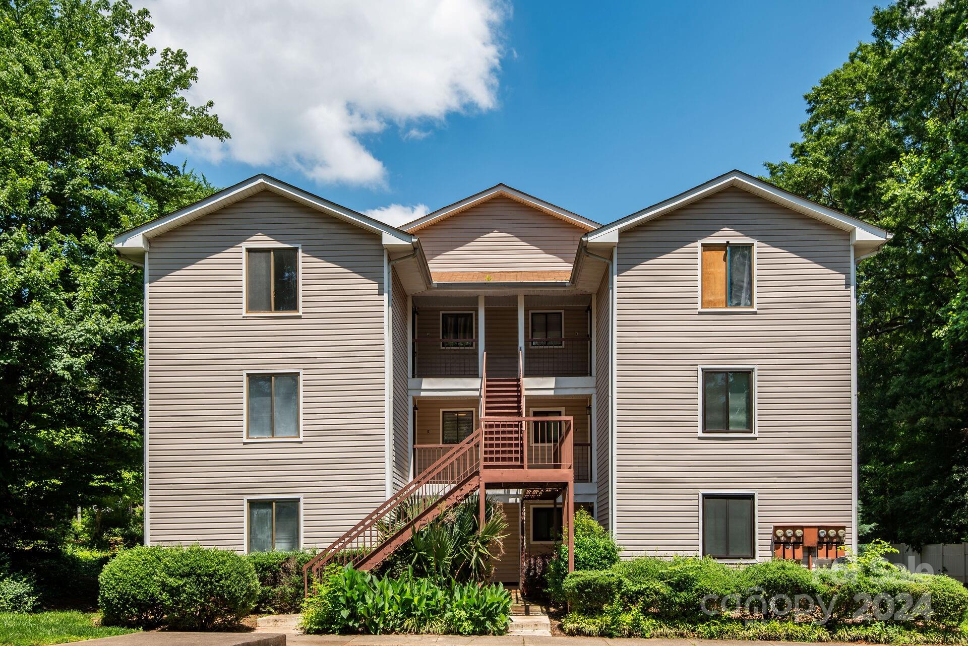 7516 Pebblestone Drive, Unit E Charlotte, NC 28212 - Photo 18 of 21 a front view of a house with a garden