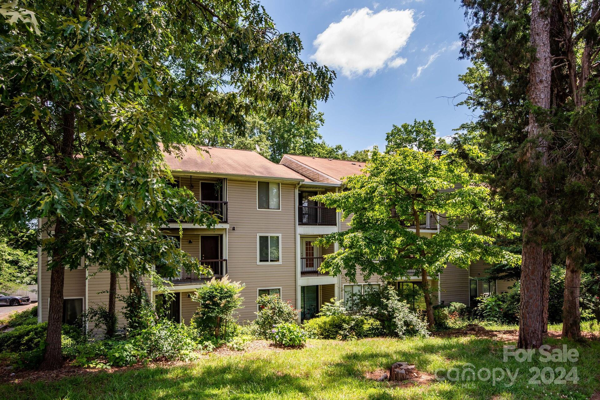 7516 Pebblestone Drive, Unit E Charlotte, NC 28212 - Photo 20 of 21 a front view of a house with a yard