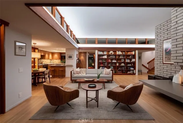 a living room with furniture a rug and white walls