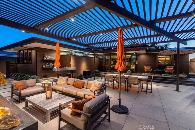 an outdoor living space with patio furniture and a fireplace