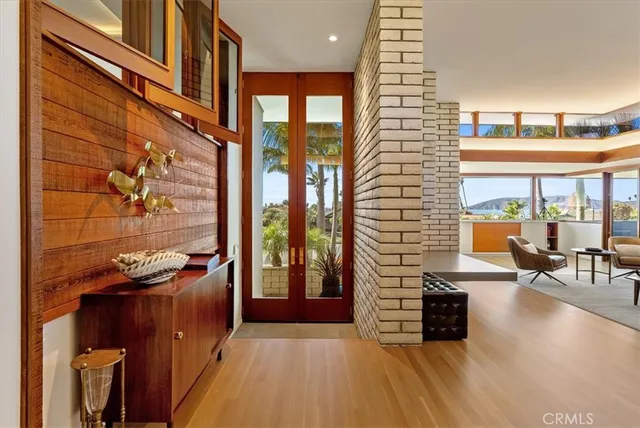 a living room with furniture a rug and white walls