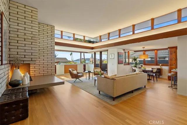 a living room with furniture and a floor to ceiling window