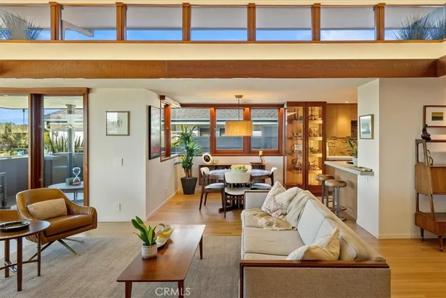 a bedroom with a bed and large windows